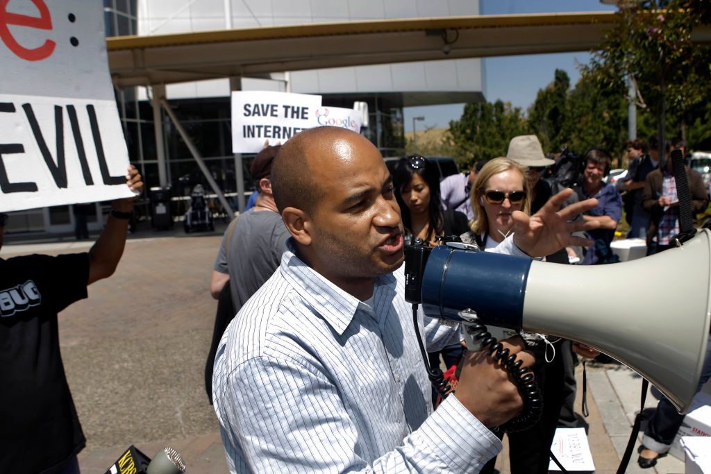 James Rucker, executive director of ColorOfChange.org which is part of the Save The Internet Coalition, speaks to activists gathered at Google's Mountain View headquarters to protest Google's altered stance on net neutrality at Google headquarters in Moun
