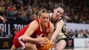 Caitlin Clark #22 of the Iowa Hawkeyes competes for the ball with Alexis Markowski #40 of Nebraska.