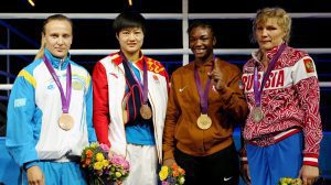 (L-R) Bronze medalist Marina Volnova of Kazakhstan, bronze medalist Jinzi Li of China, gold medalist Claressa Shields of the United States and silver medalist Nadezda Torlopova of Russia pose during the medal ceremony for the Women's Middle (75kg) Boxing final bout